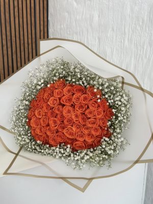 60 orange roses wrapped with baby breath