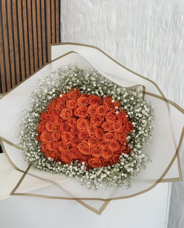 60 orange roses wrapped with baby breath